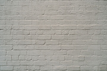 The brick wall is painted with white paint. Abstract construction background.