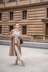 Obraz premium Young beautiful woman wearing coat walking in the city centre of Prague, Europe