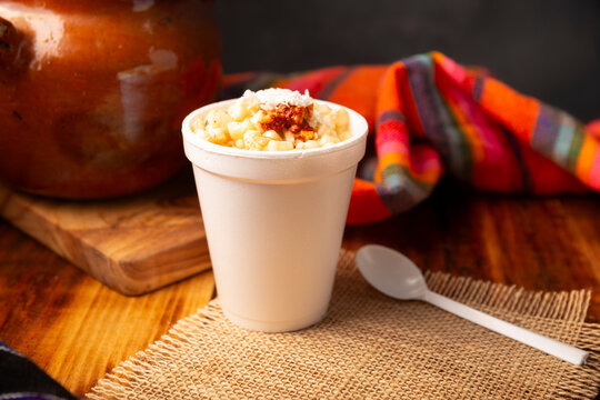 Esquites. Corn kernels cooked and served with mayo, sour cream, lemon and chili powder, very popular street food in Mexico, also known as Elote en Vaso. The recipe varies depending on the region.
