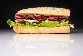 sandwich on black background with close-up reflection