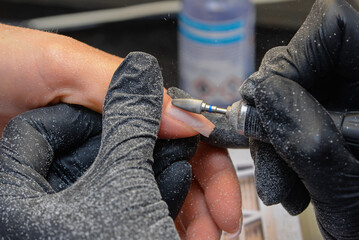 Close-up manicure process, female hands painting nails