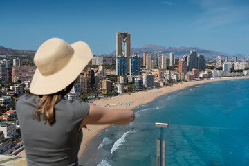 Woman standing at viewpoint called Mirador de l'Ermita Verge del Mar - looking at the panorama of...