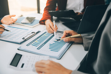 Business team working with new startup project plan and discussion information for financial strategy with laptop and digital tablet in a modern business lounge.
