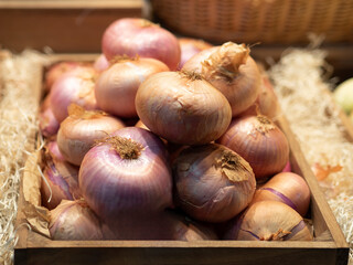 Box of onions on display for sale at the market