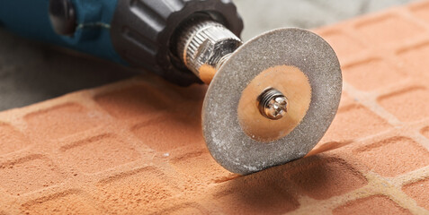 Diamond coated disc cutting brick or making grooves in concrete wall. Industry and construction.