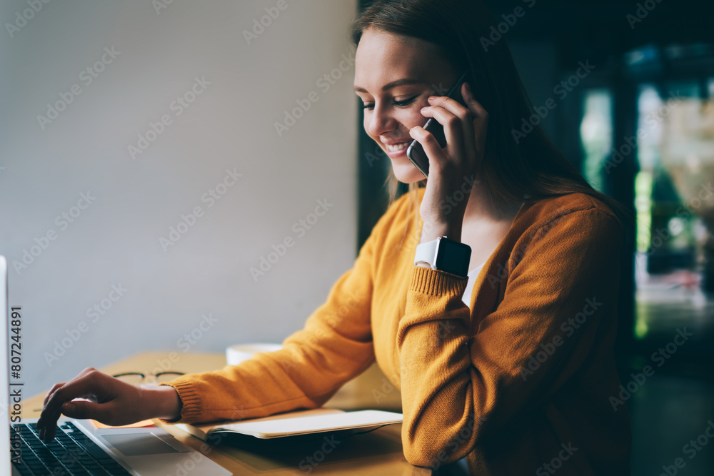 Aufkleber positive female freelancer with cute smile on face communicated with friend via smartphone device wh