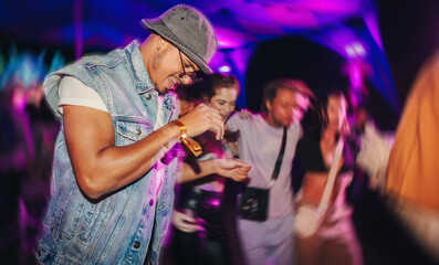 Nighttime grooves: Young people moving in sync to the beat at a music festival concert