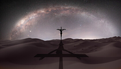 Beautiful night landscape with silhouette of Jesus on the cross on the background Milky way galaxy       