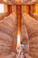 Karnak temple in the heritage city of Luxor in Egypt. Giant row of columns with carved hieroglyph
