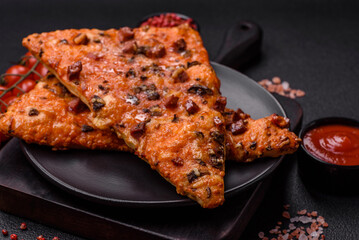 Slices of delicious street pizza with sausage, mushrooms, tomatoes and cheese