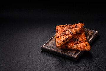 Slices of delicious street pizza with sausage, mushrooms, tomatoes and cheese