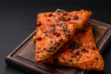 Slices of delicious street pizza with sausage, mushrooms, tomatoes and cheese