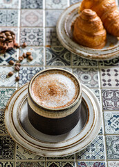 cappuccino with croissant on the table