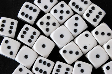 Top view of a group of dice in black background. Gambling addiction concept, rolled the die. White...