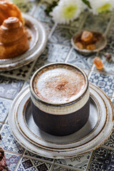 cappuccino with croissant on the table
