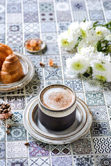cappuccino with croissant on the table