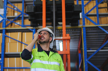 Warehouse worker working in warehouse storage. Foreman or worker work at factory site check up...