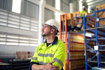 Warehouse worker working in warehouse storage. Foreman or worker work at factory site check up...