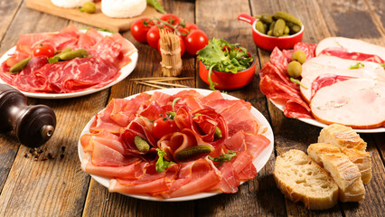 Appetizers with differents antipasti, charcuterie and snacks . Sausage, ham, tapas, olives and...