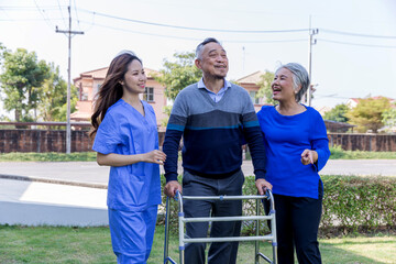 doctor or nurse helping Senior man to walk at nursing home with walker. Doctor or  nurse helping...