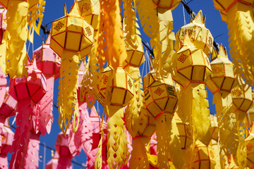 Colorful lanterns under blue sky in Thailand during Loy Krathong festival. Yellow and red lanterns...