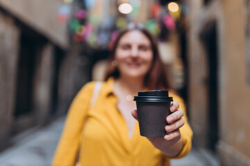 Food, rest, Take away concept. Place logo on mug, mockup. Girl hand holding paper cup on street background. Eco recycle environment friendly.