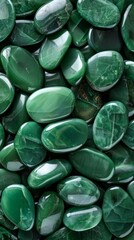 Collection of polished green malachite gemstones with natural patterns and glossy finish.