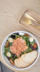 Salmon and lettuce salad with cherry tomatoes and quail eggs top view