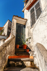 A courtyard in an Italian village. Stairs and door