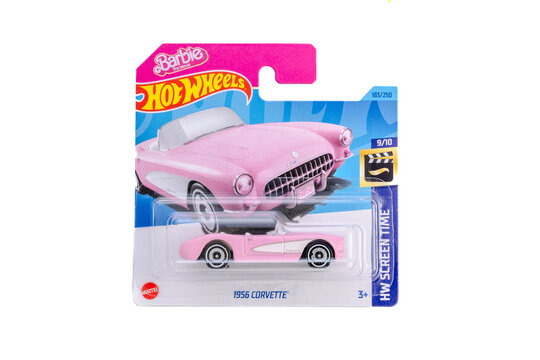 a die cast hot wheels toy unopened in packaging with plain white background. Barbie Film classic Chevrolet corvette 1956 with pink and white paint