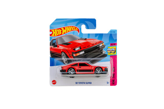 a die cast hot wheels toy unopened in packaging with plain white background. JDM. Red 1982 Toyota Supra supercar