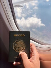 man's hand holding mexican passport