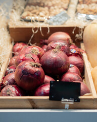 Box of onions on display for sale at the market