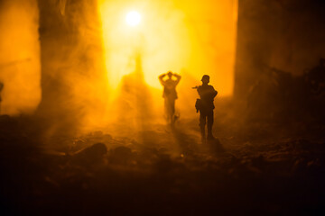 Military silhouettes fighting scene on war fog sky background. A German soldiers raised arms to...