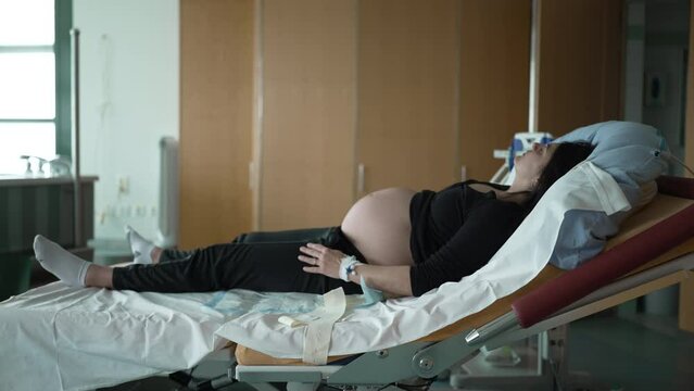 Expecting Mother Resting at Hospital in Late-Stage Pregnancy, Awaiting Prelabor Contractions