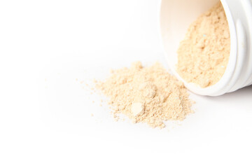 Dog styptic powder to stop bleeding wounds. Yellow powder falling out container. Pet First aid product to stop dog nail or cat claw injury from cutting. For veterinary use. Selective focus. Isolated.