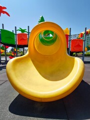 Vibrant Playground with Slide, Climbing Structure, and Carousel