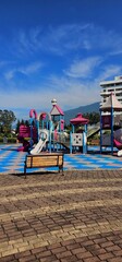 Vibrant Playground with Slide, Climbing Structure, and Carousel