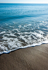 White foam from waves on a pebble sandy beach on Catalina Island in the Pacific Ocean, California