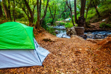 Camping in the forest, tent next to a river, at the Bridal Veil waterfall in Valle de Bravo state...