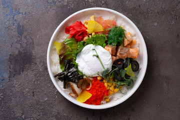 Scrumptious and colorful poke bowl with salmon, egg, and vegetables
