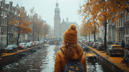 Young Woman Tourist Enjoying Autumn in Amsterdam, View From Behind Overlooking Canal and Historical...