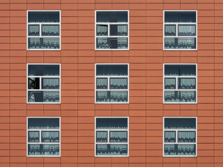abstract image of windows in a red facade of a building