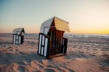 Strandkorb. wicker hooded beach chairs on a beach at the baltic sea in usedom, germany