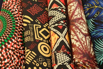 Close up of folded multi colour patterned African Ghanaian traditional cotton print cloths