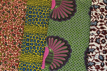 Close up of red blue yellow and green multi colour patterned African Ghanaian traditional cotton...