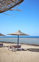 Beautiful sandy beach with sun loungers and umbrellas, Marsa Alam region, Egypt.