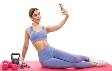 Slim, bodybuilder girl in a lilac tracksuit, sitting on the mat, she is chatting, cardio workout....