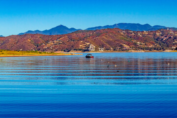Motor boat on Lake Bravo Valley with Monta4 in the background, in the state of Mexico