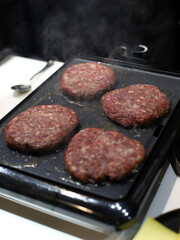 beef for hamburgers prepared on the grill for frying
